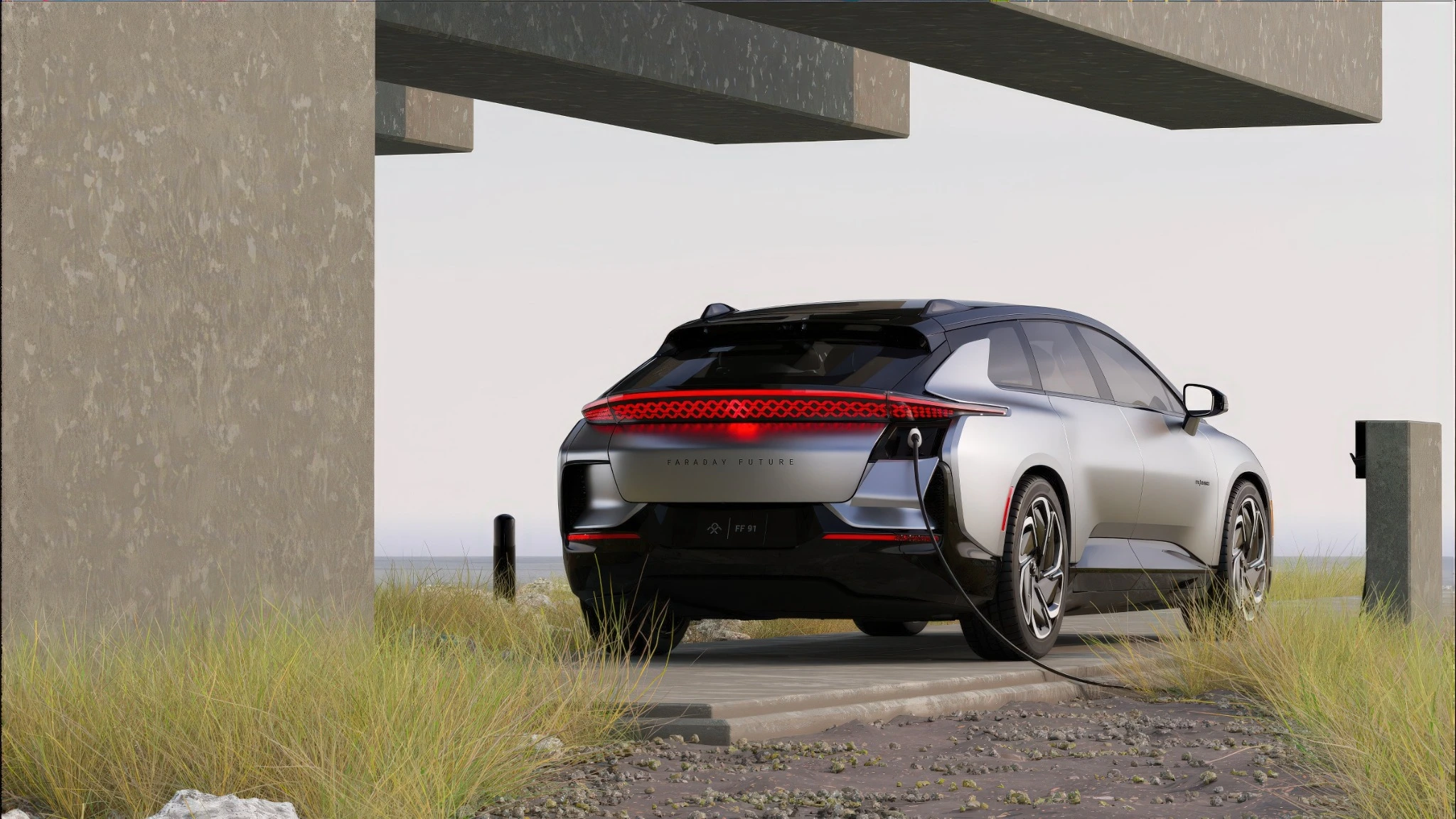 Silver Faraday Future FF91 at a charging point, viewed from the rear